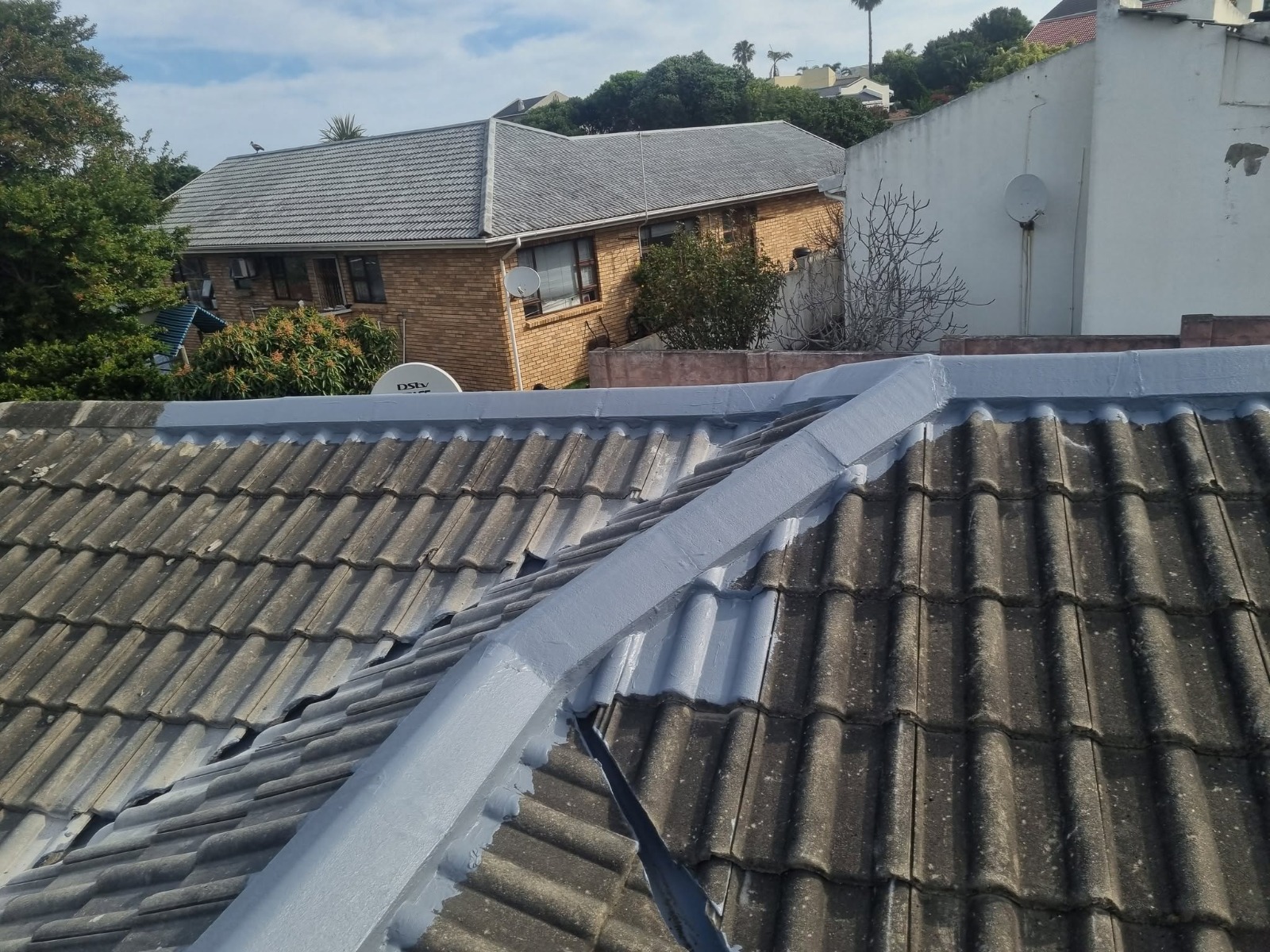 Roof ridge and parapet wall waterproofed with grey protective coating
