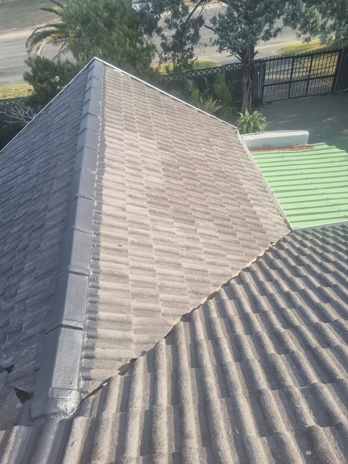 Older tiled roof ridge and vulnerable joint area prepared for waterproof sealing