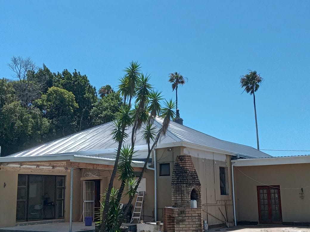Completed silver metal roof replacement with clean roof finish