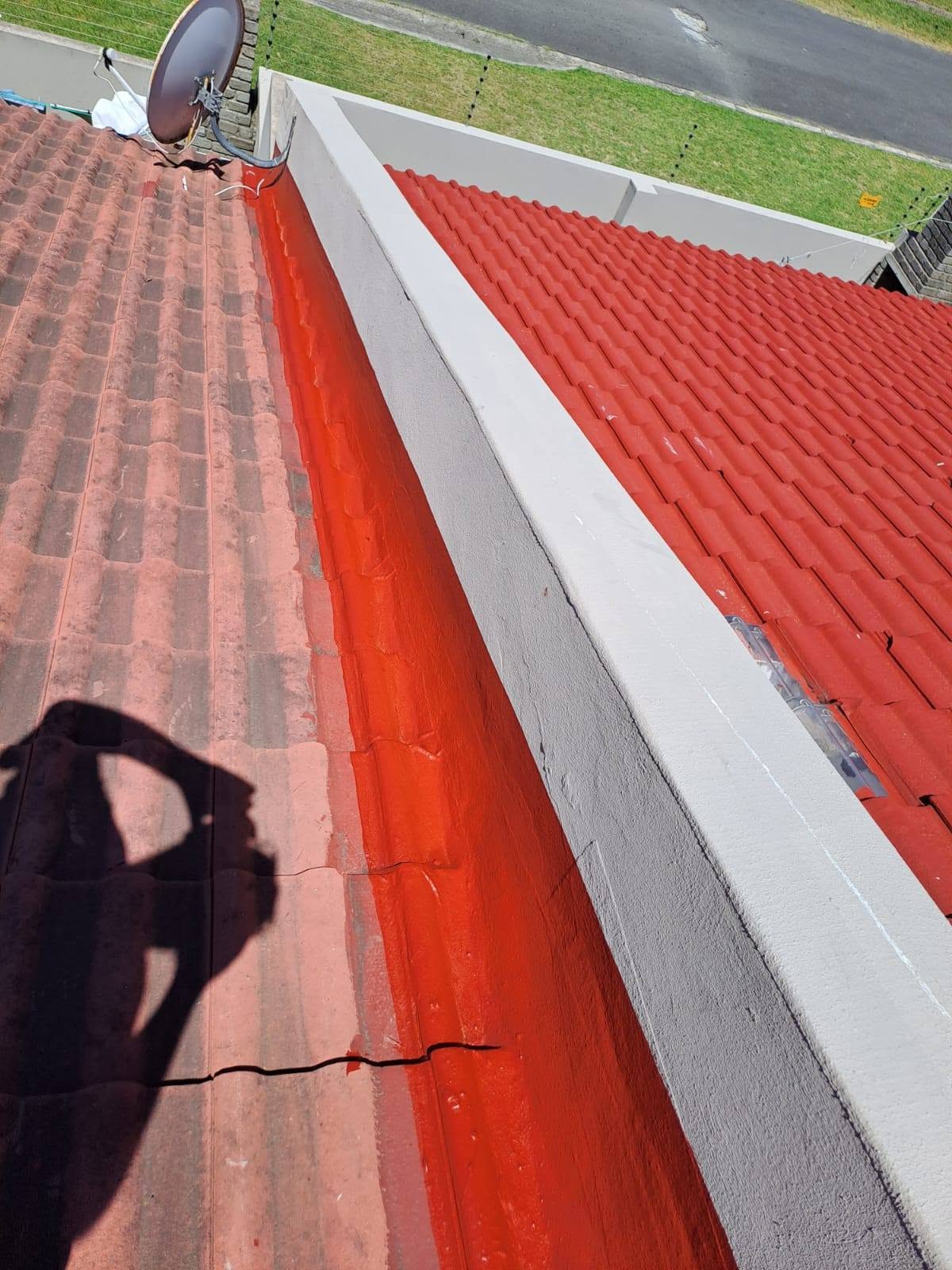 Red waterproofing applied along roof valley and gutter edge flashing area
